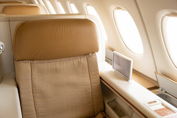Business or first class seat of the airline have brown color near windows with sun light.They feel...