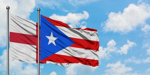 England and Puerto Rico flag waving in the wind against white cloudy blue sky together. Diplomacy concept, international relations.