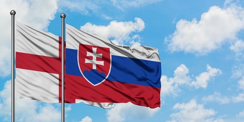 England and Slovakia flag waving in the wind against white cloudy blue sky together. Diplomacy concept, international relations.