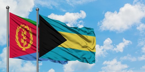 Eritrea and Bahamas flag waving in the wind against white cloudy blue sky together. Diplomacy concept, international relations.