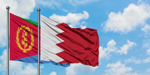 Eritrea and Bahrain flag waving in the wind against white cloudy blue sky together. Diplomacy concept, international relations.