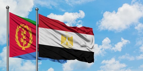 Eritrea and Egypt flag waving in the wind against white cloudy blue sky together. Diplomacy concept, international relations.