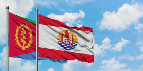 Eritrea and French Polynesia flag waving in the wind against white cloudy blue sky together. Diplomacy concept, international relations.