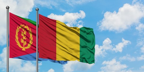 Eritrea and Guinea flag waving in the wind against white cloudy blue sky together. Diplomacy concept, international relations.