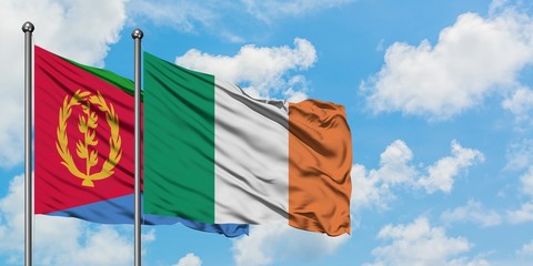 Eritrea and Ireland flag waving in the wind against white cloudy blue sky together. Diplomacy concept, international relations.
