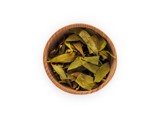 Dry Viscum leaves in wooden Cup on white background