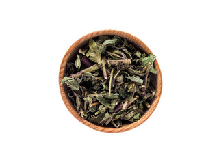 Dry leaves of Mentha piperita in a wooden Cup on a white background