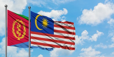 Eritrea and Malaysia flag waving in the wind against white cloudy blue sky together. Diplomacy concept, international relations.