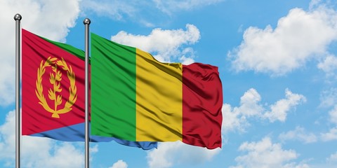 Eritrea and Mali flag waving in the wind against white cloudy blue sky together. Diplomacy concept, international relations.