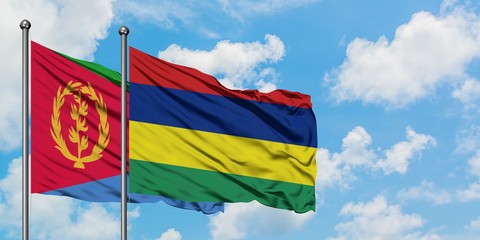 Eritrea and Mauritius flag waving in the wind against white cloudy blue sky together. Diplomacy concept, international relations.