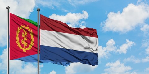 Eritrea and Netherlands flag waving in the wind against white cloudy blue sky together. Diplomacy concept, international relations.