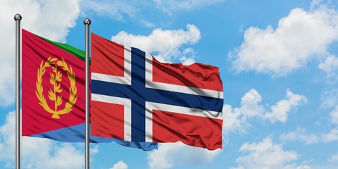 Eritrea and Norway flag waving in the wind against white cloudy blue sky together. Diplomacy concept, international relations.