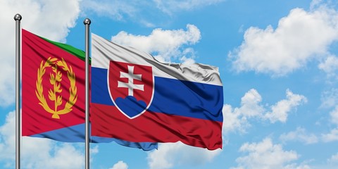 Eritrea and Slovakia flag waving in the wind against white cloudy blue sky together. Diplomacy concept, international relations.
