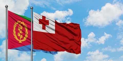 Eritrea and Tonga flag waving in the wind against white cloudy blue sky together. Diplomacy concept, international relations.