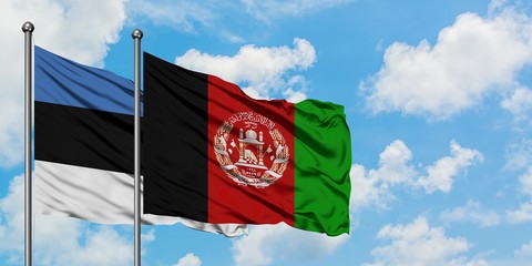 Estonia and Afghanistan flag waving in the wind against white cloudy blue sky together. Diplomacy...