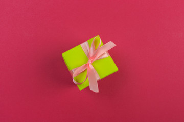 Gift box with ribbon and bow on color background and space for text. Top view - Image