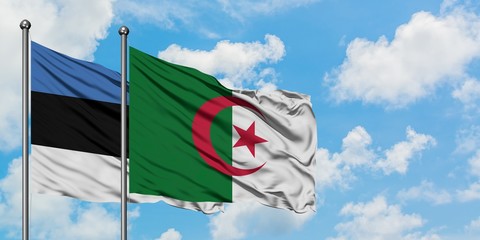 Estonia and Algeria flag waving in the wind against white cloudy blue sky together. Diplomacy...