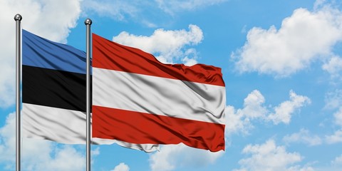 Estonia and Austria flag waving in the wind against white cloudy blue sky together. Diplomacy concept, international relations.