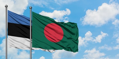 Estonia and Bangladesh flag waving in the wind against white cloudy blue sky together. Diplomacy...