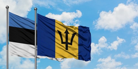 Estonia and Barbados flag waving in the wind against white cloudy blue sky together. Diplomacy concept, international relations.