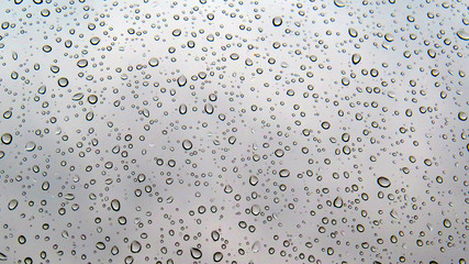 Texture of water drops on glass. Transparent droplets on glass after rain