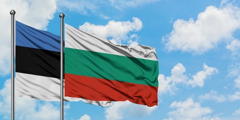Estonia and Bulgaria flag waving in the wind against white cloudy blue sky together. Diplomacy concept, international relations.