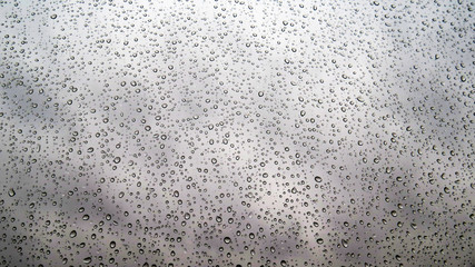 Texture of water drops on glass. Transparent droplets on glass after rain