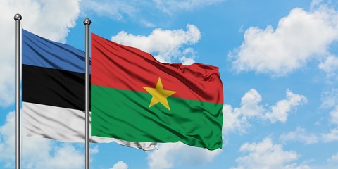 Estonia and Burkina Faso flag waving in the wind against white cloudy blue sky together. Diplomacy concept, international relations.