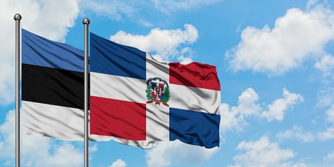Estonia and Dominican Republic flag waving in the wind against white cloudy blue sky together. Diplomacy concept, international relations.