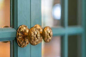 Classic retro brass door knob on green door vintage decoration retro interior style