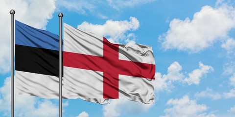 Estonia and England flag waving in the wind against white cloudy blue sky together. Diplomacy concept, international relations.