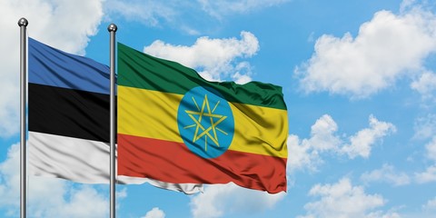 Estonia and Ethiopia flag waving in the wind against white cloudy blue sky together. Diplomacy concept, international relations.