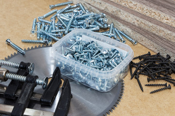 Screws, confirmations for furniture, tape measure, clamp, lie on the table. Furniture production