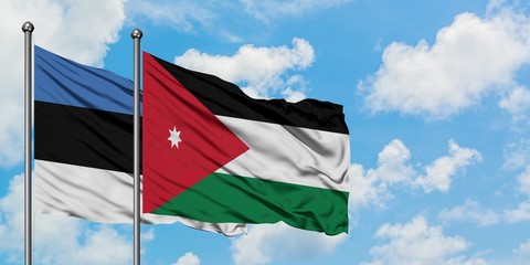 Estonia and Jordan flag waving in the wind against white cloudy blue sky together. Diplomacy concept, international relations.
