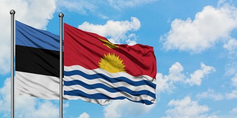 Estonia and Kiribati flag waving in the wind against white cloudy blue sky together. Diplomacy concept, international relations.