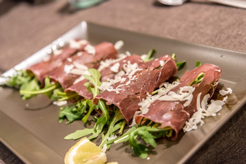 Antipasto with bresaola, rucola and parmesan cheese served in a restaurant in Western Sicily, Italy