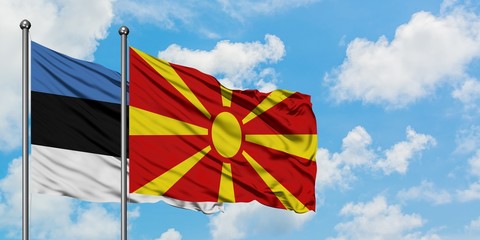 Estonia and Macedonia flag waving in the wind against white cloudy blue sky together. Diplomacy concept, international relations.
