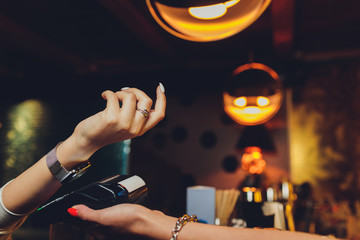 Woman pay by smart watch with NFC technology.