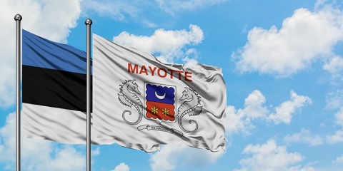 Estonia and Mayotte flag waving in the wind against white cloudy blue sky together. Diplomacy concept, international relations.