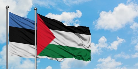 Estonia and Palestine flag waving in the wind against white cloudy blue sky together. Diplomacy concept, international relations.