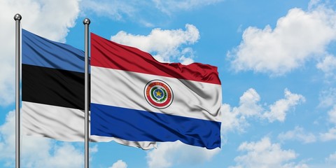 Estonia and Paraguay flag waving in the wind against white cloudy blue sky together. Diplomacy concept, international relations.