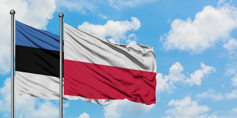 Estonia and Poland flag waving in the wind against white cloudy blue sky together. Diplomacy concept, international relations.