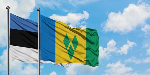 Estonia and Saint Vincent And The Grenadines flag waving in the wind against white cloudy blue sky together. Diplomacy concept, international relations.