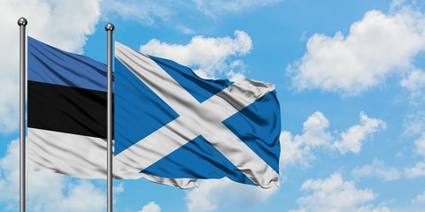Estonia and Scotland flag waving in the wind against white cloudy blue sky together. Diplomacy concept, international relations.