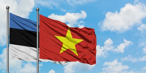 Estonia and Vietnam flag waving in the wind against white cloudy blue sky together. Diplomacy concept, international relations.