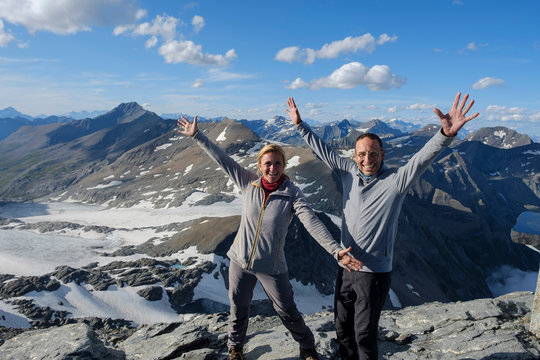 A pair of mountaineers reached the summit of Rocciamelone and is enjoying the wonderful view over the Italian Alps