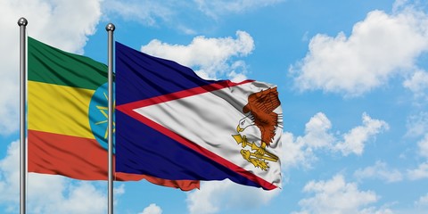 Ethiopia and American Samoa flag waving in the wind against white cloudy blue sky together....