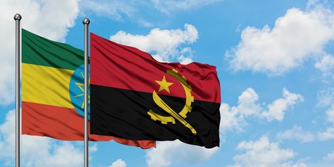 Ethiopia and Angola flag waving in the wind against white cloudy blue sky together. Diplomacy concept, international relations.