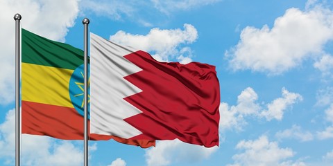 Ethiopia and Bahrain flag waving in the wind against white cloudy blue sky together. Diplomacy concept, international relations.