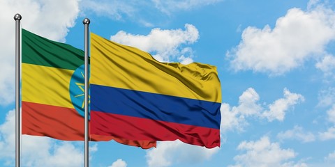 Ethiopia and Colombia flag waving in the wind against white cloudy blue sky together. Diplomacy concept, international relations.
